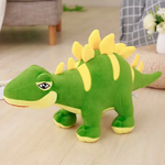 Green Stegosaurus dinosaur plush with yellow back plates on a rug