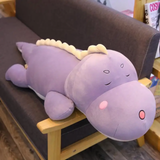 Purple dinosaur plush body pillow with a cream ridge lying on a sofa