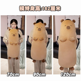 Size comparison of tan capybara bolster pillows at 70cm, 90cm and 120cm next to a woman