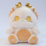 White fluffy baby dragon plush with golden horns and sparkly star eyes, close-up of face on light background.