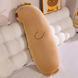 Long tan capybara body pillow with a gold crown leaning on a cloud headboard