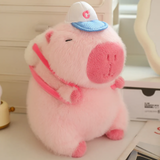 Pink capybara plush with a white cap and a pink strap