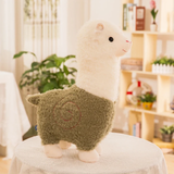 Green body alpaca plush with a white head and a stitched swirl on a table