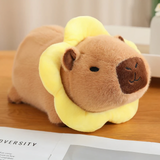 Capybara plush with a yellow flower collar on a wooden table