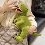 A person holds a green plush dinosaur toy with a smiling face and sharp teeth, wearing a light-colored shirt.
