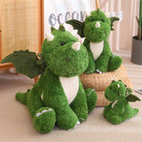 Green plush dinosaur with wings, featuring three sizes sitting together on a woven basket.