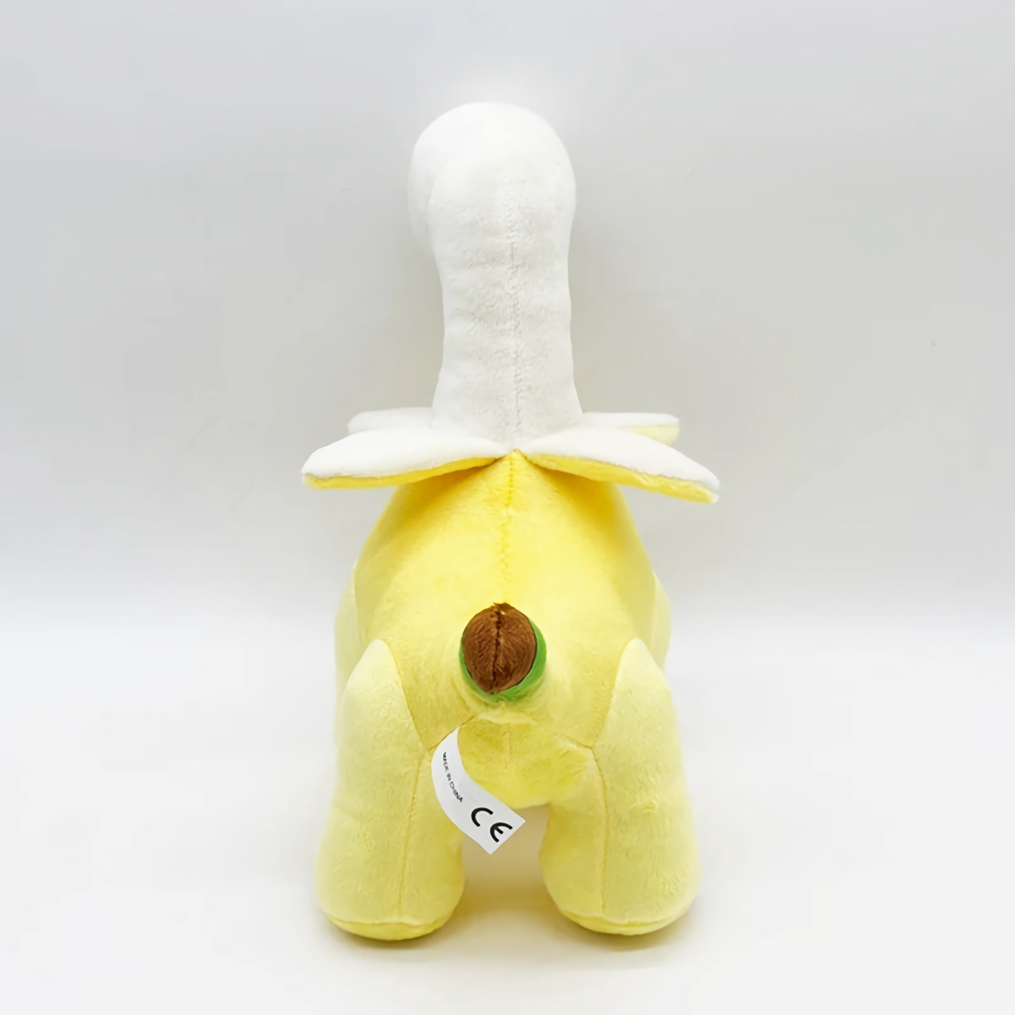 Plush toy shaped like a dinosaur with a banana design, featuring a yellow body and white details.