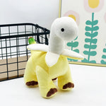 Plush toy resembling a dinosaur with a yellow body and a white neck, featuring a banana-like design.