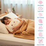 Child sleeping with a cat-shaped pillow, wrapped in a cozy blanket, in a softly lit bedroom.