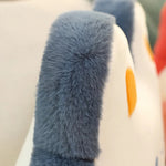 Close-up of a plush pillow with soft, gray fur and colorful accents.