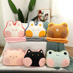 A set of six plush pillows shaped like animals, with colorful blankets stacked behind them.