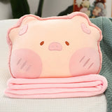 Plush pillow shaped like a pig with a pink blanket folded underneath it.