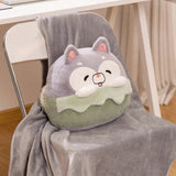 A plush pillow shaped like a cartoon animal rests on a gray blanket draped over a chair.