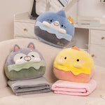 Three plush pillows shaped like animals with two folded travel blankets in gray and pink.