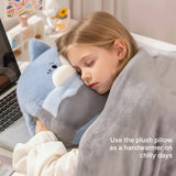 A child sleeps with a plush pillow while wrapped in a soft blanket, resting on a desk with a laptop.