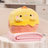 Yellow and pink plush toy with a folded pink blanket on a table.
