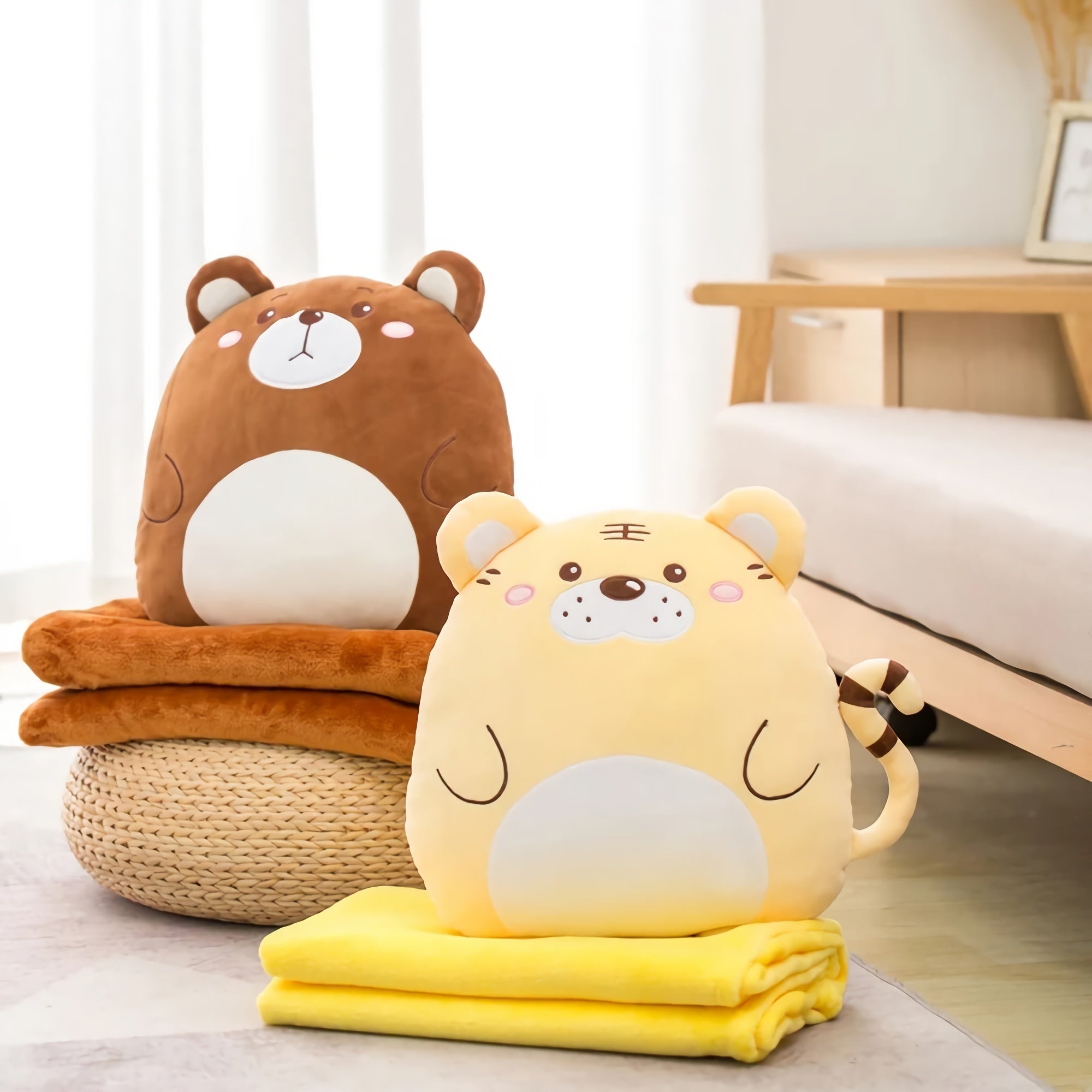 A brown bear plush pillow and a yellow tiger plush pillow sit on folded blankets in a cozy room.