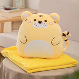 Yellow plush tiger pillow on a folded yellow blanket on a table.