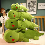 A stack of green dinosaur plush pillows with cute facial features, next to a person in a casual outfit.