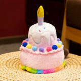 Kawaii plush pillow shaped like a birthday cake with a candle and colorful pom-poms on top.