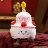Kawaii plush pillow shaped like a birthday cake with a candle, strawberries, and a smiling face.
