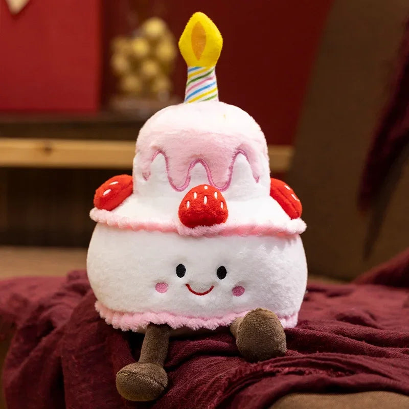 Kawaii plush pillow shaped like a birthday cake with a candle, strawberries, and a smiling face.
