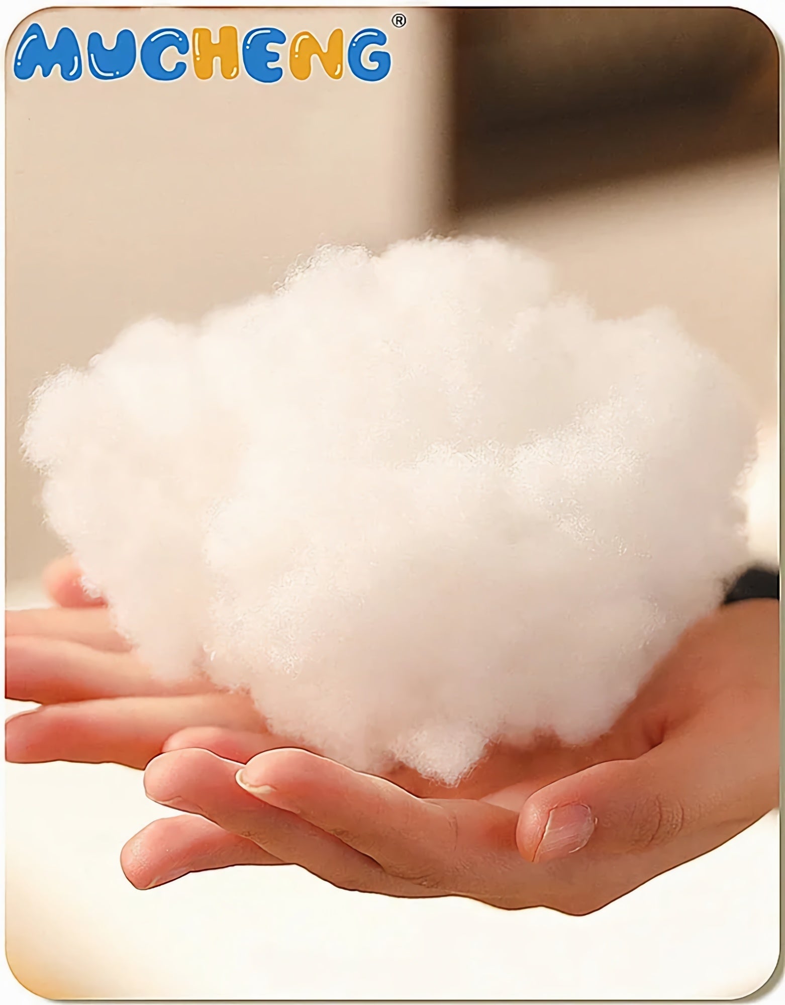 A person holding a fluffy, white pillow filling in their hands.