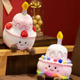 Kawaii plush pillows shaped like birthday cakes, featuring candles and colorful decorations, sitting on a wooden shelf.