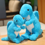 Two blue plush dinosaur toys, one larger and one smaller, with white bellies, standing on a wooden surface.
