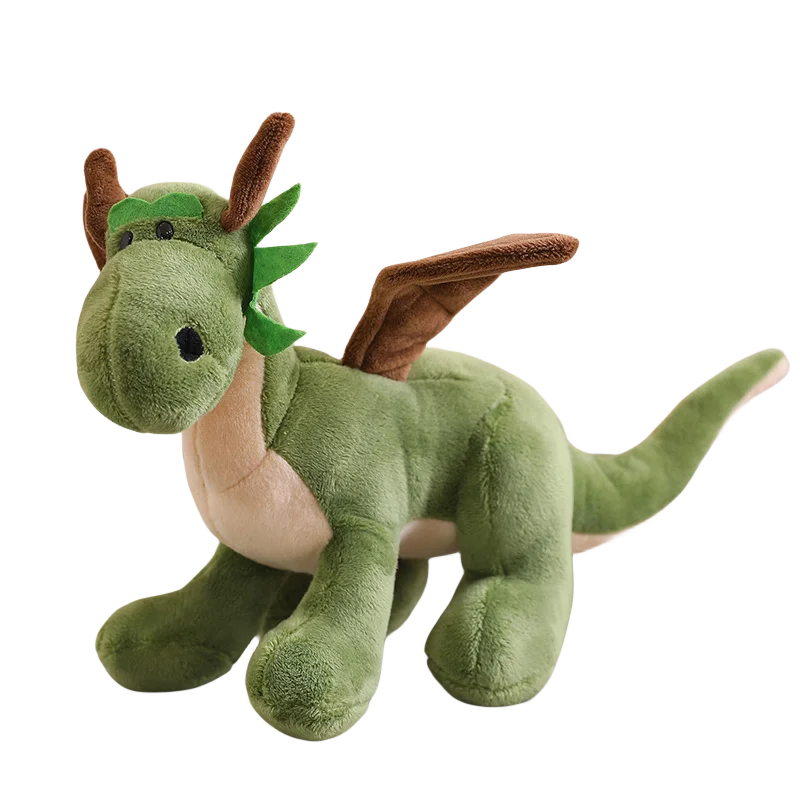 A green plush dragon with wings, large eyes, and a friendly expression, sitting on a flat surface.