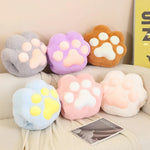 Colorful plush paw-shaped cushions in various pastel shades arranged on a light-colored surface.