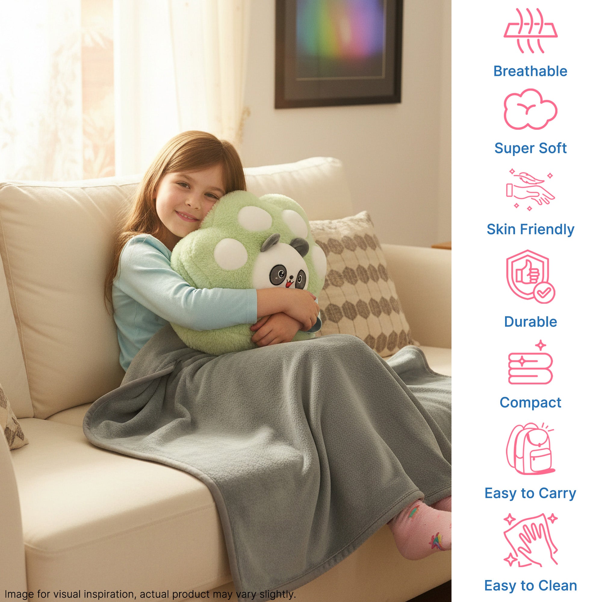Girl sitting on a couch, hugging a plush toy, wrapped in a gray blanket. Soft, cozy indoor setting.