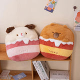 Two plush pillows shaped like a bear and a dog, with pastel colors and cute facial features, resting on a wooden shelf.