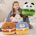 Girl sitting with a gray blanket, holding plush pillows shaped like a panda, dog, bear, and penguin.
