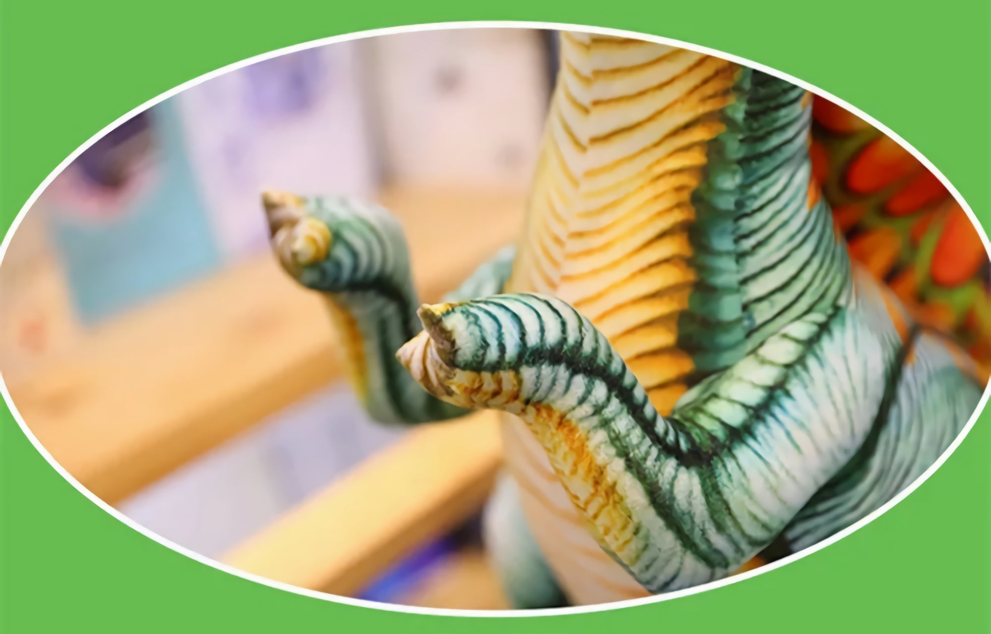 Close-up of a plush dinosaur toy's textured claws and striped body against a blurred background.