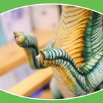 Close-up of a plush dinosaur toy's textured claws and striped body against a blurred background.