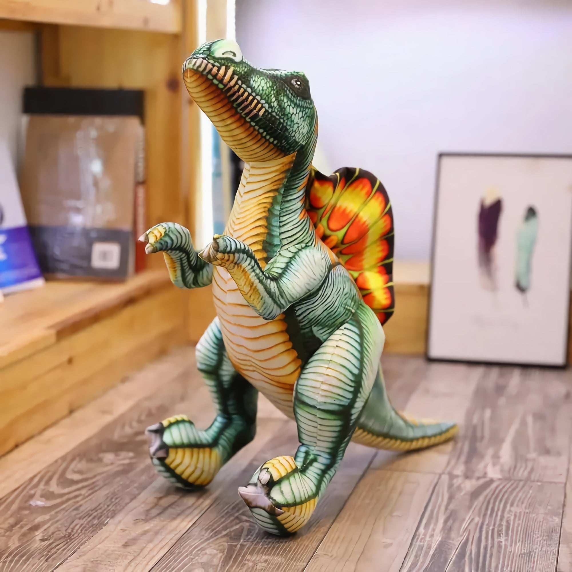 Lifelike Spinosaurus plush pillow with vibrant colors, standing on a wooden floor with art in the background.