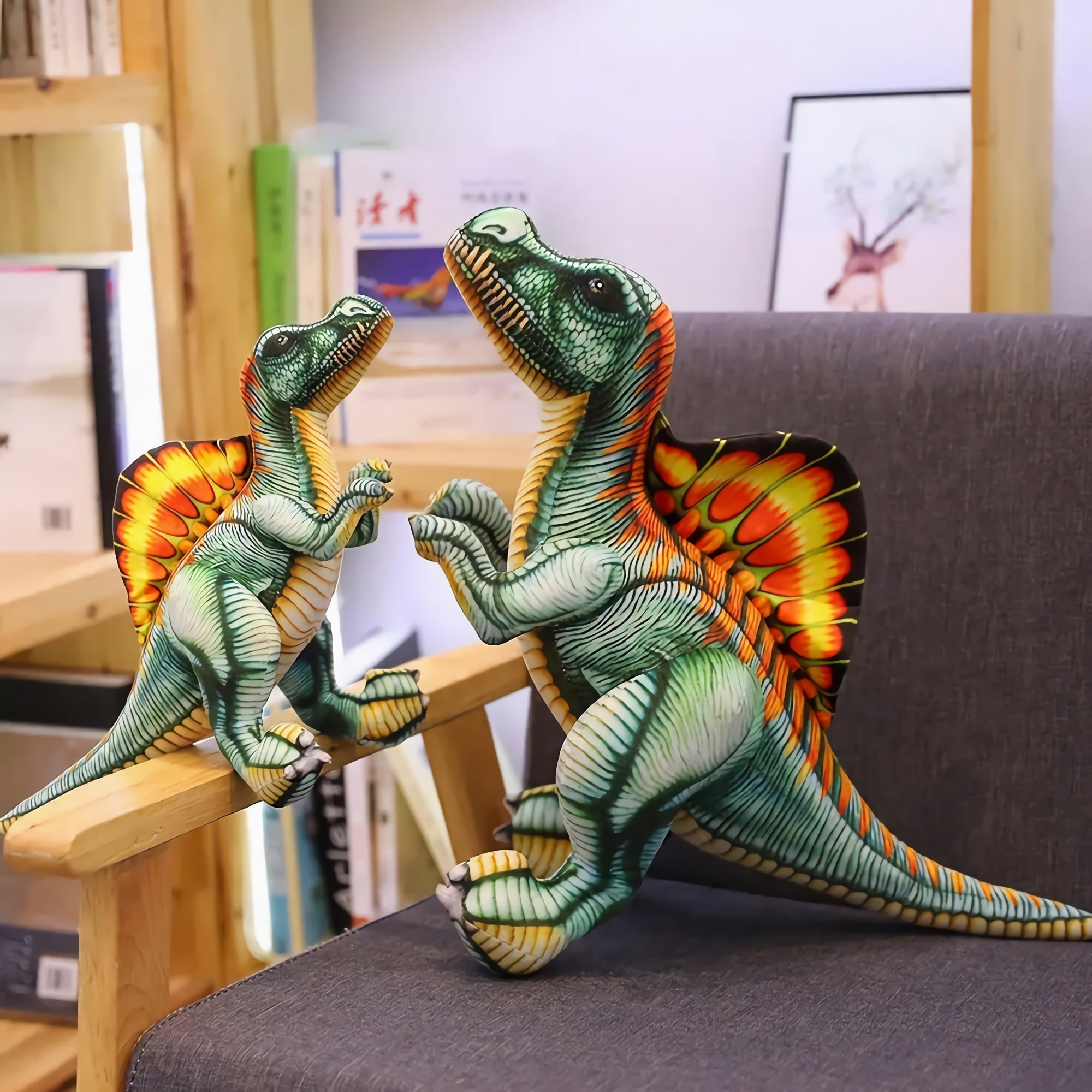 Two Spinosaurus plush toys in vibrant colors, one larger and one smaller, displayed on a chair in a cozy setting.