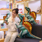 A person sits on a couch with colorful Spinosaurus plush toys, contemplating while holding one in their hand.
